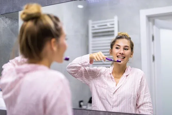 woman brushing her teeth
