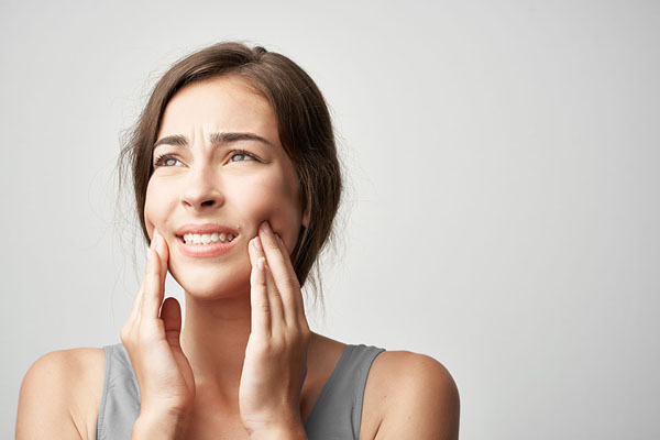 woman dealing with tooth pain from possible dental infection