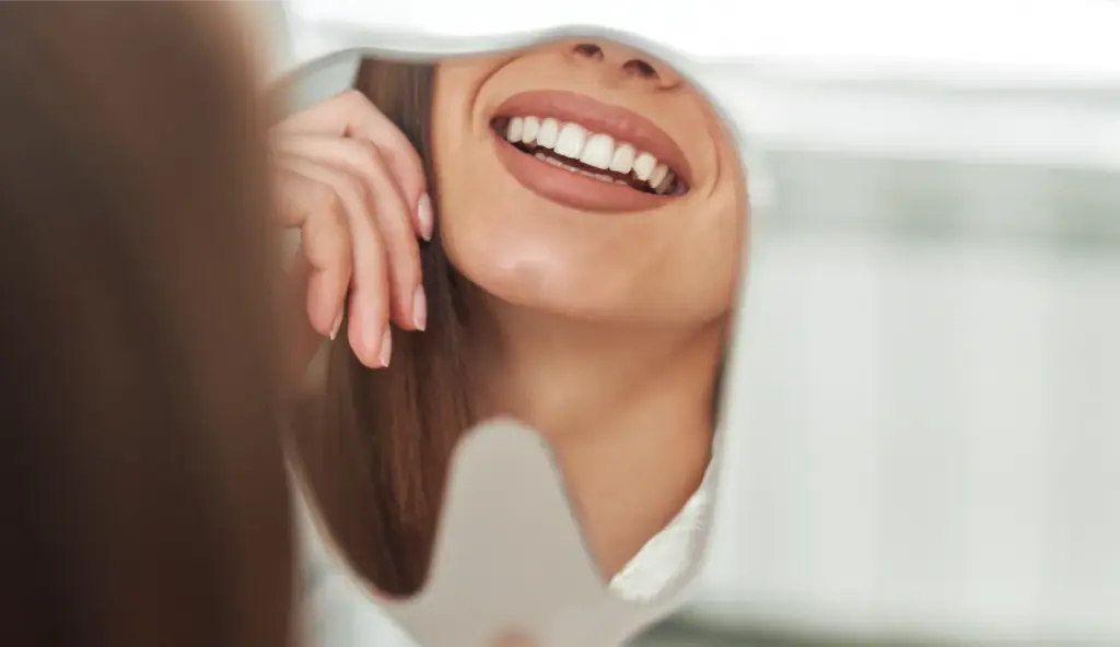 Woman smiling with white teeth after treatment