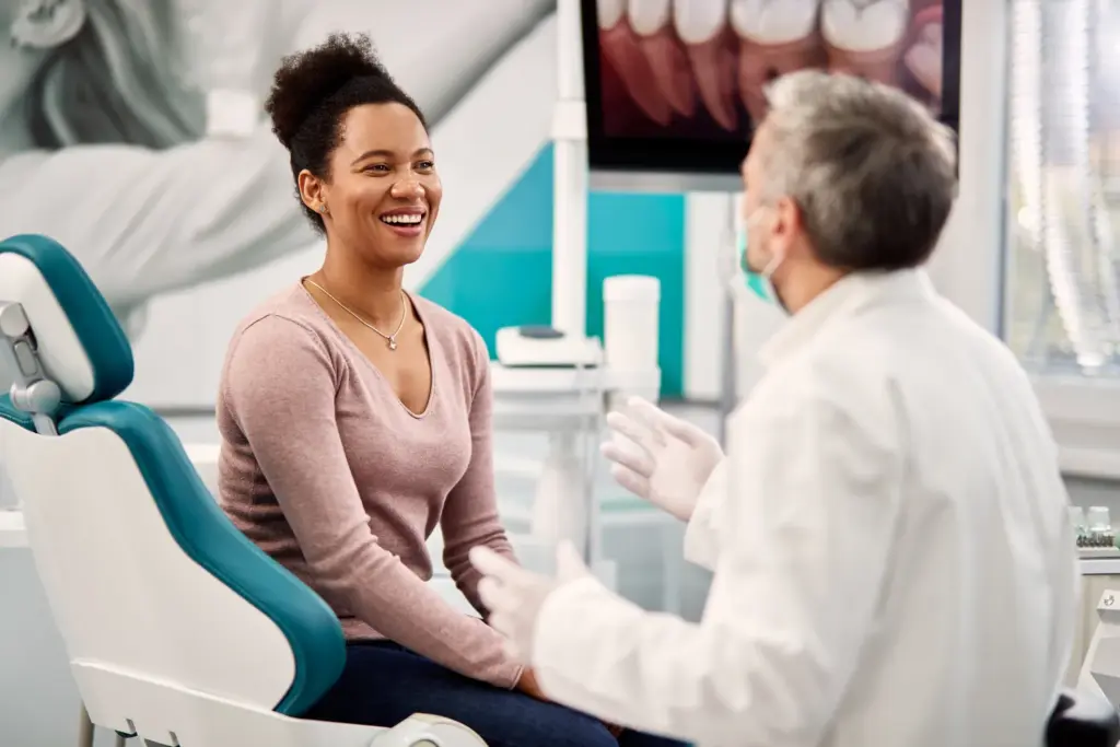 Woman consulting dentist during routine examination