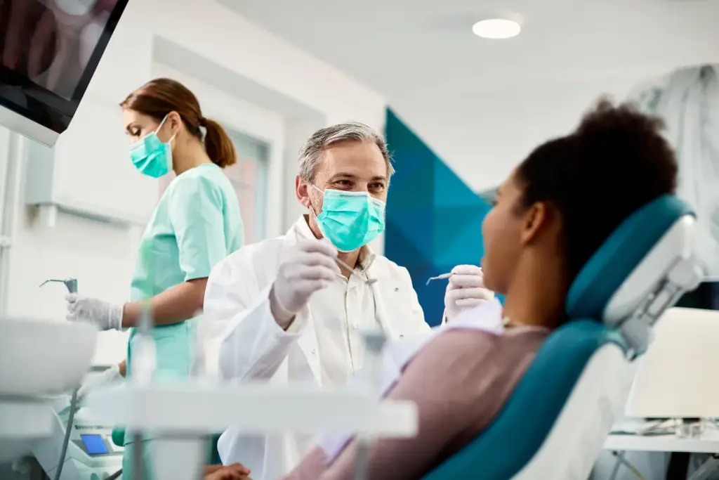 Dental team treating patient in clinic operatory