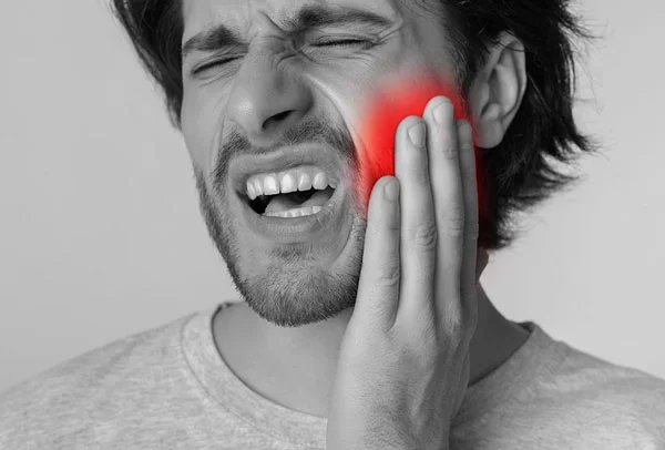 man in pain from the left side of his mouth