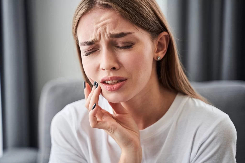 woman experiencing intense tooth pain